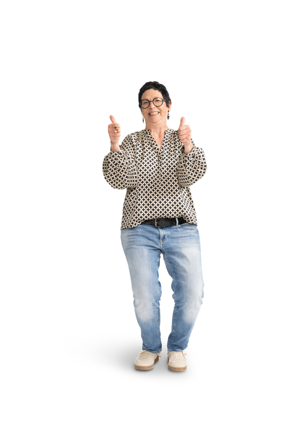 Eine Frau mir kurzen, schwarzen Haaren, Brille, gemusterter Bluse und Jeans.